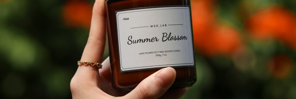 a person holding a jar of honey in their hand